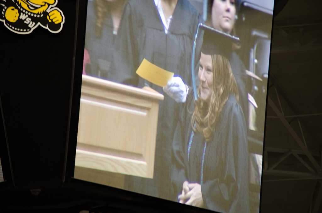 Nikki on the big screen ready to accept her degree