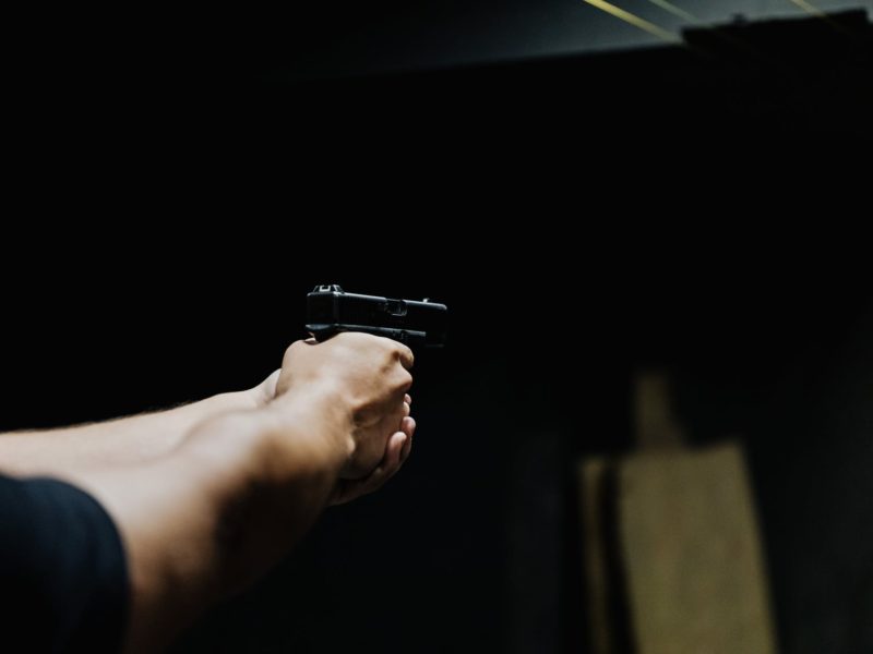 a person holding a handgun